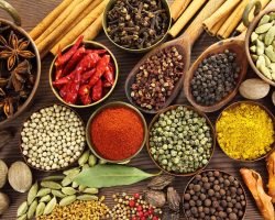 Spices and herbs in metal  bowls and wooden spoons. Food and cuisine ingredients.